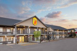 a hotel with a sign on the front of it at Super 8 by Wyndham Fort McMurray in Fort McMurray