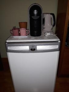 a black appliance sitting on top of a white refrigerator at Anne's House in San Giuliano Terme