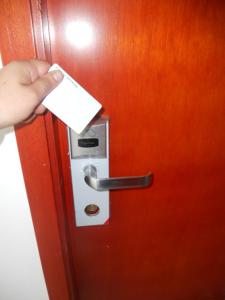 a person is putting a piece of paper into a door at Hotel Manzanares Baranoa in Baranoa