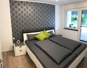 默讷塞Auszeit am See的一间卧室，配有一张大床和一堵墙