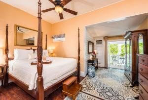 a bedroom with a bed and a mirror at Old Town Manor in Key West