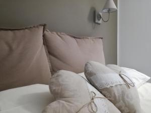a white bed with pillows and a lamp on it at Casa Rossini in Turin