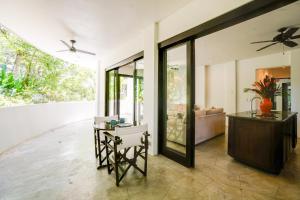 a living room with a ceiling fan and a table at Makara Suite Mariposa Ground Floor in Uvita