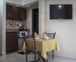 a table with a yellow table cloth on it in a kitchen at Apparts-hôtel ISNI in Agadir