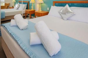 a bedroom with two beds with white pillows at Broadbeach in Gold Coast +26 photos