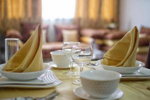 una mesa con platos, tazones y copas de vino en Apparts-hôtel ISNI en Agadir