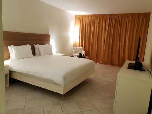 Postel nebo postele na pokoji v ubytování Hotel Arawak Beach Resort