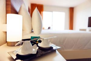 Postel nebo postele na pokoji v ubytování Hotel Arawak Beach Resort