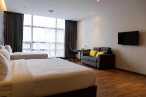 a hotel room with a bed and a desk at Imperial Regency Suites & Petaling Jaya in Kuala Lumpur