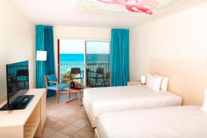 Postel nebo postele na pokoji v ubytování Hotel Arawak Beach Resort