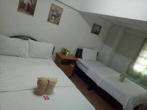 Rúm í herbergi á TT Hostel Chiangrai