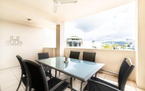 a dining room with a table and chairs at Cairns City Apartments in Cairns
