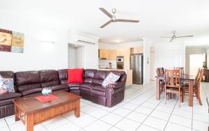 a living room with a couch and a table at Cairns City Apartments in Cairns