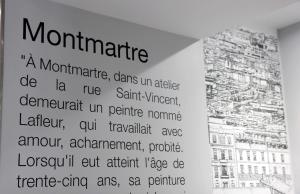 a sign in a room with a building at Hotel Litteraire Marcel Ayme, BW Premier Collection in Paris