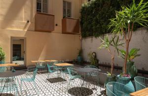 a patio with tables and chairs and plants at Best Western Plus H&ocirc;tel La Joliette in Marseille