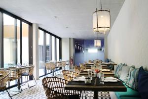 a dining room with tables and chairs and windows at Best Western Plus Hôtel La Joliette in Marseille