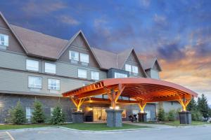 a large house with a large building at Super 8 by Wyndham Canmore in Canmore