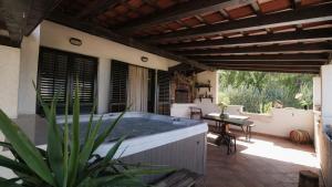 a hot tub on the patio of a house at Villa Gem in Mravince
