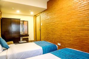 Ένα ή περισσότερα κρεβάτια σε δωμάτιο στο Gaju Suite Hotel