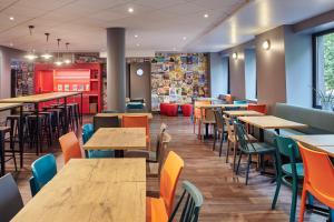 a dining room with wooden tables and chairs at hotelF1 Paris Porte de Châtillon in Paris