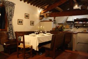 a dining room with a table with candles on it at villa la chiesetta - private pool and Jacuzzi - Borgo Canapegna in Fabriano