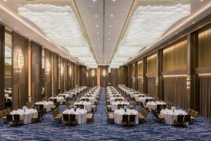 a banquet hall with tables and chairs in a building at Mytt Hotel Pattaya in Pattaya +25 photos