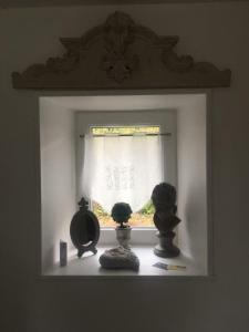 a window with some vases on a window sill at Chambres d'Hôtes La Clef des Champs in Montpinchon