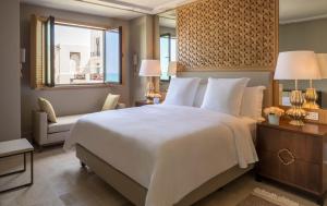 a bedroom with a large white bed and a window at Four Seasons Hotel Tunis in Gammarth