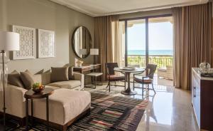 a living room with a couch and a table at Four Seasons Hotel Tunis in Gammarth