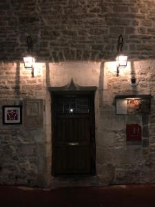 eine Tür in einem Backsteingebäude mit Licht drauf in der Unterkunft Abbaye de Maizières in Beaune