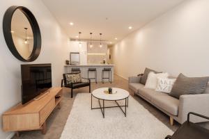 a living room with a couch and a table at Character City Loft in Auckland