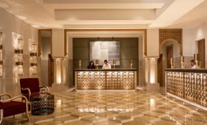 a lobby of a hotel with people in the mirror at Four Seasons Hotel Tunis in Gammarth