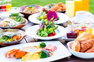 uma mesa de madeira com pratos de comida em Okuma Private Beach & Resort em Kunigami