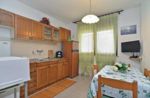 a kitchen with a table and a dining room at Apartment with nice terrace 684 in Štinjan
