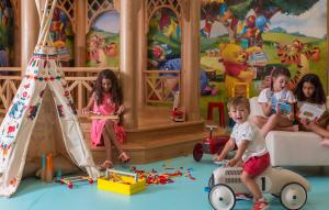 a group of children sitting in a play room with toys at Four Seasons Hotel Tunis in Gammarth