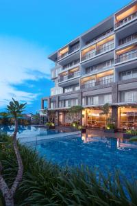 an image of a hotel with a swimming pool at Hotel Santika Banyuwangi in Banyuwangi