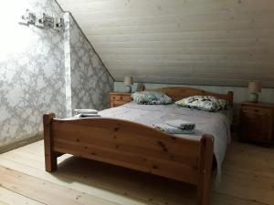 a bedroom with a bed and a dresser at Brīvdienu māja Melderi in Ape