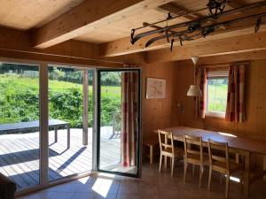 uma sala de jantar com uma mesa de madeira e cadeiras em Woody Park Chalet 14 em Kaindorf