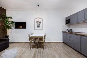 a kitchen and dining room with a table and chairs at NY7 Apartment in downtown in Budapest
