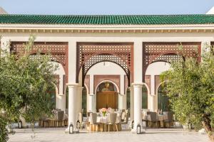 a courtyard of a building with tables and chairs at Four Seasons Hotel Tunis in Gammarth