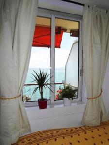 a bedroom with a window with a view of the ocean at Cros De Cagnes in Cagnes-sur-Mer