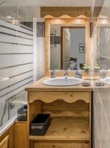 a bathroom with a sink and a mirror at Hauts de Préclaux By Infini Mountain in Les Orres