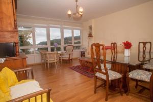 a dining room and living room with a table and chairs at Beatiful holiday flat in Galicia with sea views and next to the "Camino de Santiago" in Estorde