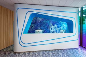 a blue and white refrigerator with a cartoon character on it at prizeotel Hamburg-St.Pauli in Hamburg