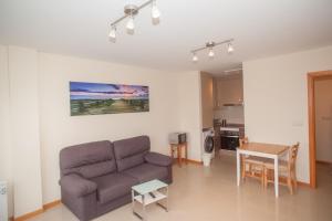 a living room with a couch and a table at Beatiful holiday flat in Finisterre with sea views and next to the "Camino de Santiago" in Finisterre