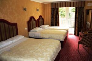 
A bed or beds in a room at Buckatree Hall Hotel
