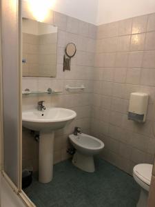 a bathroom with a sink and a toilet at Hotel Cherubini in Rome