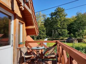 a patio with a table and chairs on a balcony at vinico in Piechowice