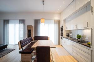 a kitchen with a table and a dining room at Premium Business Apartment in Oberkochen in Oberkochen