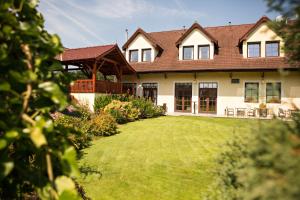 a large house with a large lawn in front of it at Pivovarský dvůr Zvíkov in Zvíkovské Podhradí